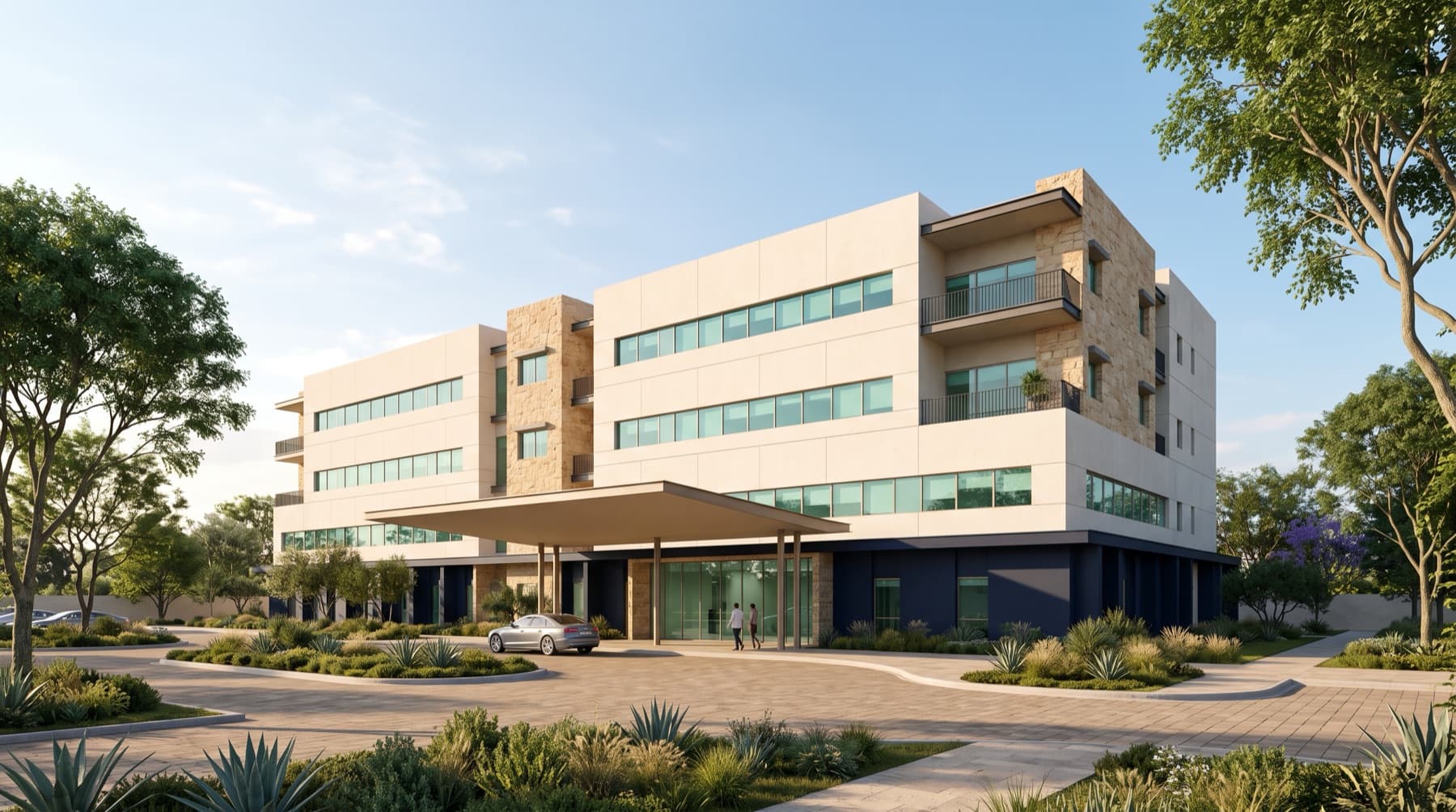 Exterior de un hospital de cuatro niveles con acceso techado, fachada clara y planta baja en azul marino.